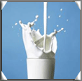 Milk splashing into a glass
